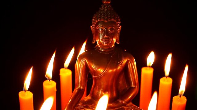 Buddha statue and candle in the dark, Chiangmai Thailand