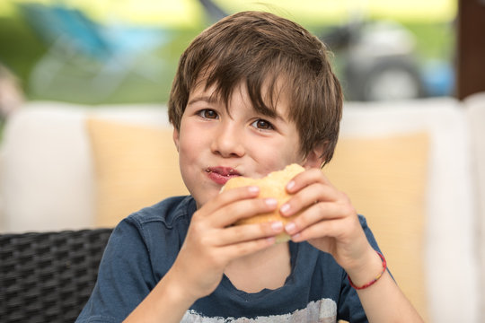 child eating a hamburger