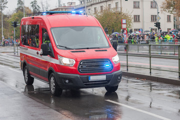 Fire brigade workers riding cars on military parade