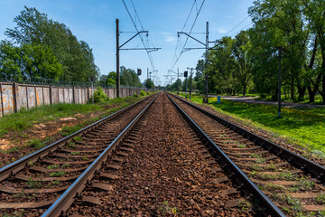 Fototapeta na wymiar Railroad Tracks for Electric Train in Riga, Latvia on a Clear Sunny Day