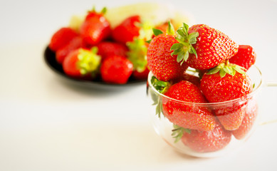 strawberries in a glass on a white background