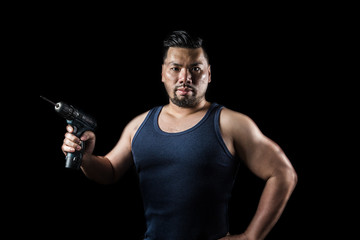 A man with an electric screwdriver，Auto mechanic，Asian man