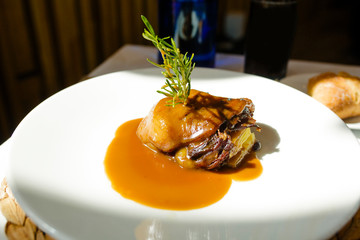 Duck confit dish decorated with rosemary
