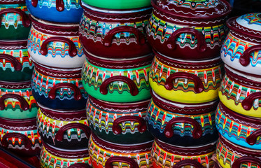 Traditionally decorated colorful souvenir pots in tourist shop, Bulgaria.