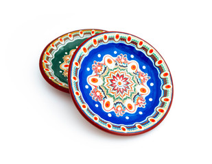Blue bulgarian traditional plate, souvenir decorated dish with Balkan floral ornament. Isolated on white background.
