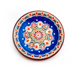 Blue bulgarian traditional plate, souvenir decorated dish with Balkan floral ornament. Isolated on white background.