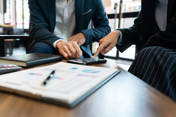 Business team cooperation coworking discussing about progress of business plan project advice and correcting mistakes during work in the Office