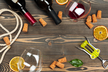 Bottle of wine and cork and corkscrew on wooden table