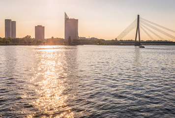 Bank of Daugava river i Riga city, view with modern office buildings and Vansu Bridge, Latvia