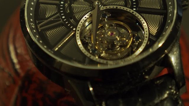 Beautiful watch movement on a beautiful red tea pot.