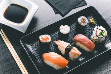 Sushi on wood table. Elegant japanese restaurant. Retro style
