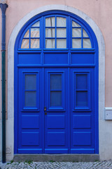 blue wooden door with wooden panels in the historic part of Lisbon
