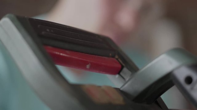 Close up portrait of young master engineer in unifrom glasses focused on drilling a hole with perforator