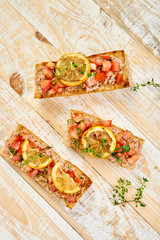 Appetizer bruschetta with tuna and tomatoes. Italian cuisine.