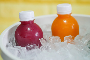 the bottles of cold pressed fruit and vegetables juice in the ice bucket.