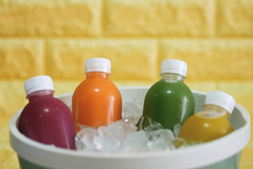 the bottles of cold pressed fruit and vegetables juice in the ice bucket.