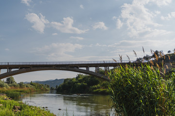 Muddy river flowing under bridge. Redriver in Turkey