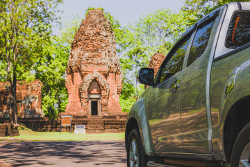 Tourists use cars to explore Khmer castles, ancient Prang Ku Suan Taeng, in Buriram, Thailand.