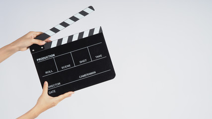Fototapeta na wymiar Hands is holding black Clapperboard or movie slate. it use in video production ,film, cinema industry on white background.