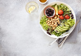 Detox salad with chick pea, avocado, grilled tomatoes and olives. Healthy salad bowl for super food, clean eating, plant based diet concepts.