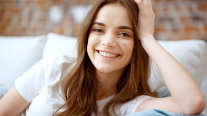 Beautiful smiling brunette looking at the camera.