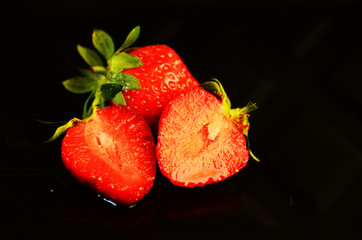Ripe strawberries  on black background, photo,red sweet berry.