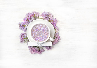 Obraz na płótnie Canvas Beautiful lilac flowers in Cup. concept of spring. may month calendar. still life with spring flowers lilac in cup on white background. Top view, flat lay, copy space.
