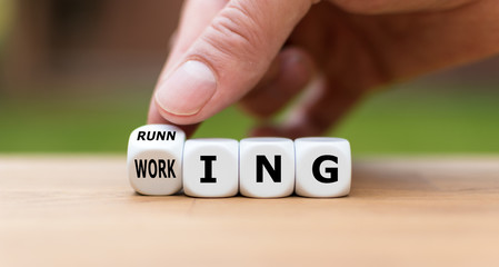 Symbol for running instead of working. Hand turns a dice and changes the word "working" to "running".