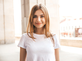 Portrait of beautiful blond model dressed in summer hipster clothes. Trendy girl posing in the...