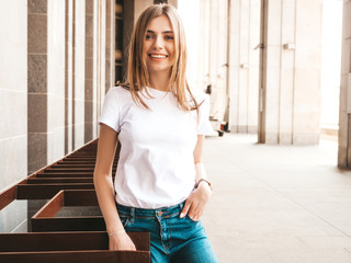 Portrait of beautiful blond model dressed in summer hipster clothes. Trendy girl posing in the...