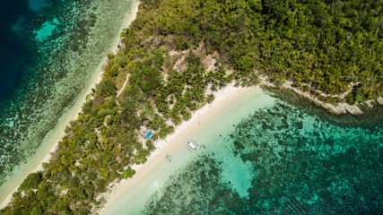 Beautiful aerial view of a tropical isolated island in Port Barton, Palawan, The Philippines