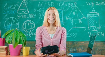 Confident woman in virtual reality headset pointing in air. Modern education. Back to school. Virtual education. Virtual reality gadget. Virtual cyber space. Augmented reality. Woman in VR glasses