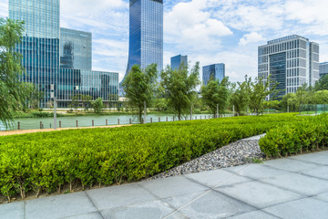 beautiful green meadow near modern office building.