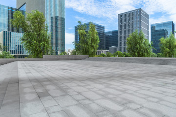 empty pavement and modern buildings in city.