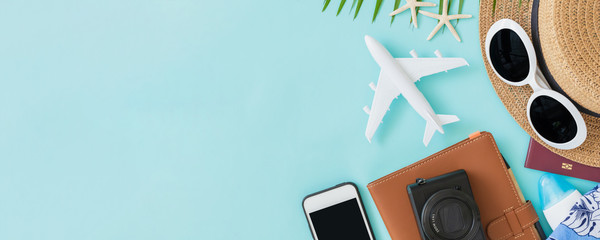 Top view of traveler accessories, tropical palm leaf and airplane on blue background with empty space for text. Travel summer holiday vacation banner concept. - 268983042