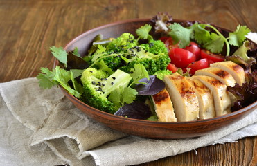 Healthy nutrition - bowl with fried chicken, broccoli, vegetables