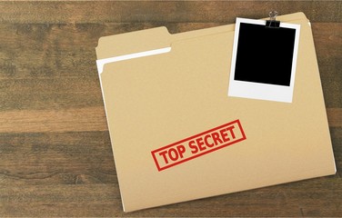 Folder  with the words Top Secret stamped on it, Isolated on a white background.