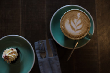 Cappuccino on a wooden table. The cake. View from above.