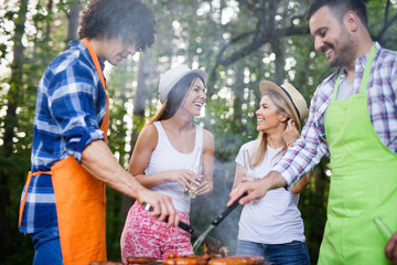 Group of friends having a barbecue party in nature