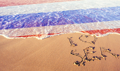 Beach sand, sea and flag Thailand. I love Thailand concept