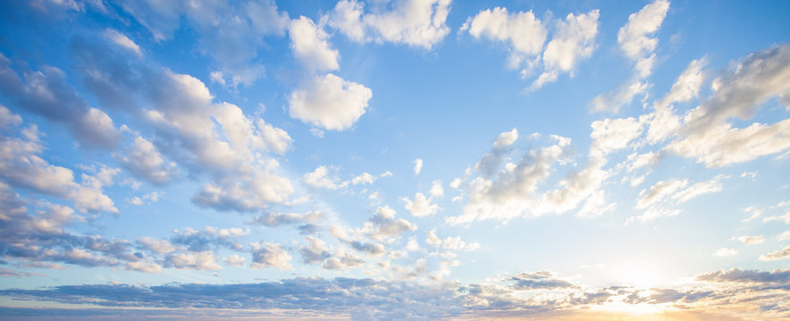 Blue sky clouds background, Beautiful landscape with clouds and orange sun on sky © millaf