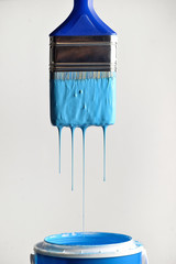 Dripping blue paint from brush