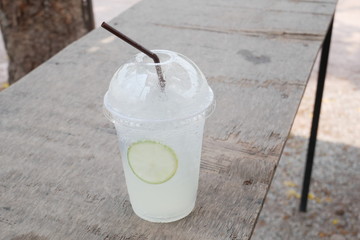 liquid cocktail on wood background, fresh lemonade summer drink 