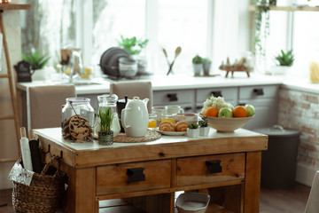 Photo of stylish wooden table being placed in the kitchen