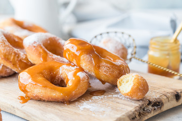 Glazed caramel doughnuts. A close up of fresh glazed doughnuts in a studio setting. donut
