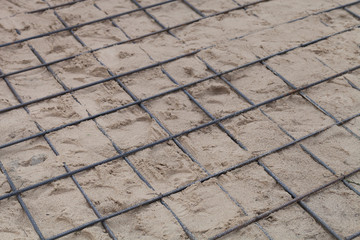 The metal fittings laid in sand. Preparation for pouring concrete. Selection focus. Shallow depth of field