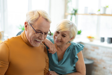 Face-portrait of loving elegant aging woman tenderly looking at husband