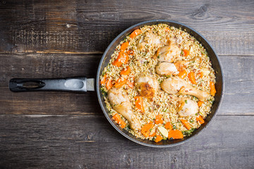 Fried rice with vegetables and chicken in pan. Selective focus.