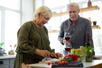 Bewitching woman cutting veggies for the romantic dinner