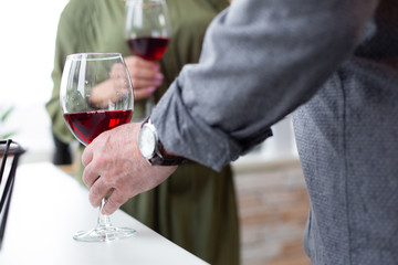 Close-up shot of male hand holding a glass.